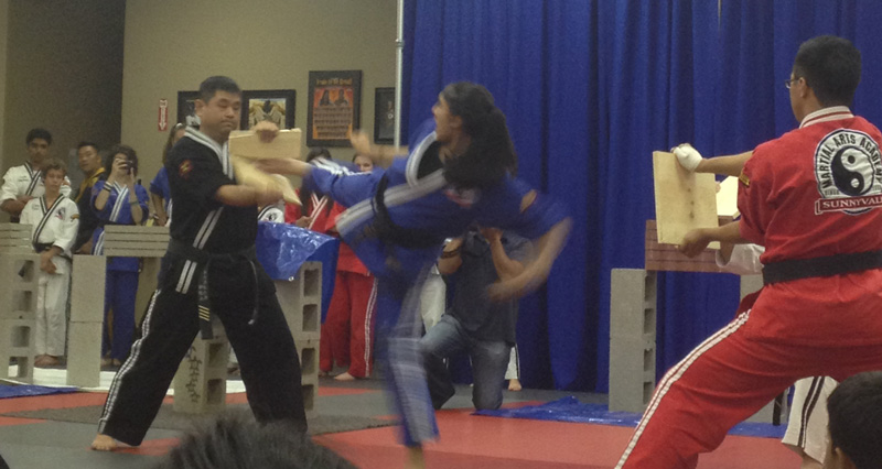 Leela Amladi performing a Taekwando kick to earn her 3rd dan black belt.